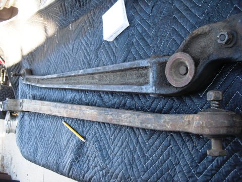 1986 Ford Bronco - Vehicle suspension parts are shown on a blue mat, with a pencil for scale.