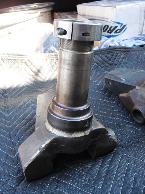 1986 Ford Bronco - This automotive part, a spindle and knuckle assembly, is shown up close on a protective mat.