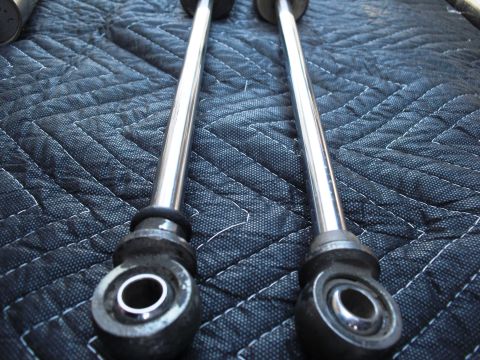 1986 Ford Bronco - Close-up of two shock absorbers, likely for an off-road vehicle, displayed on a textured mat.
