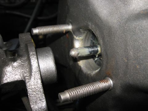 1981 Ford Bronco - Detail of a brake booster pushrod and mounting hardware, showing lubrication and threaded fasteners.
