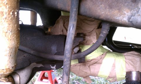 1979 Ford Bronco - Close-up of vehicle undercarriage components, including brake lines and suspension parts.