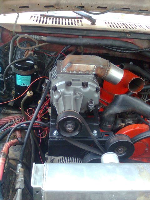 1984 Ford Bronco - Custom supercharger installation in an engine bay, with various hoses and wiring present.