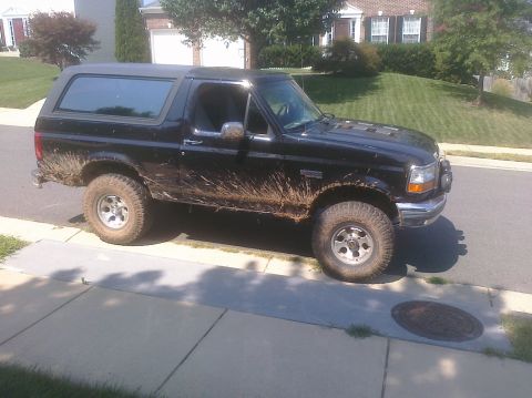 1995 Ford Bronco - This 1995 Ford Bronco is shown from the side, heavily coated in mud after off-road use.