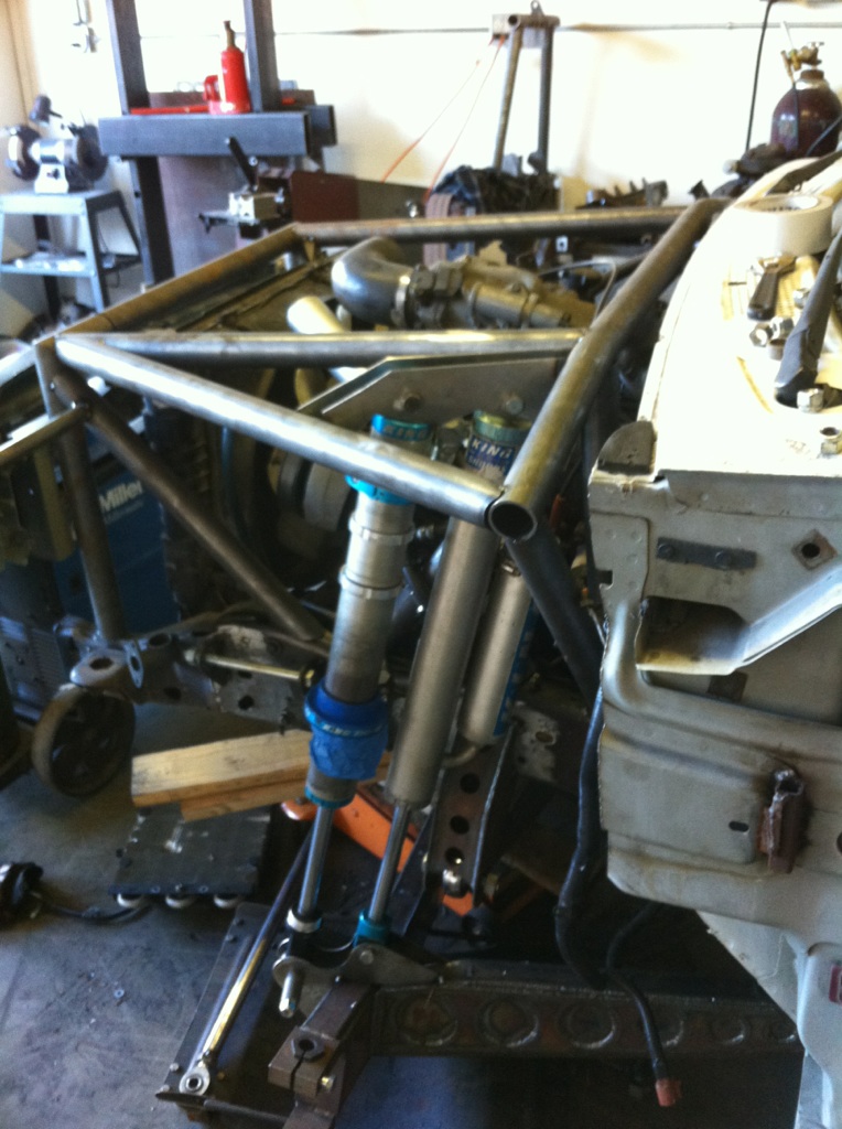 Custom off-road chassis with exposed engine and suspension components