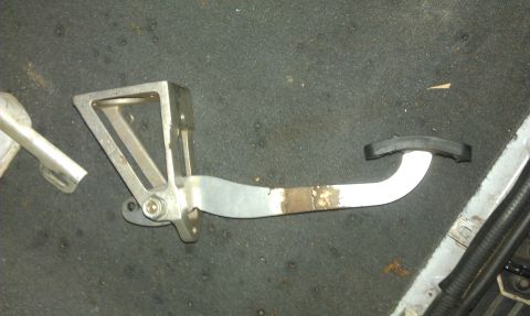 1992 Ford Ranger - A close-up view of a vehicle's brake pedal assembly, showing its metal construction and rubber grip.