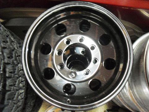 1986 Ford Bronco - A single chrome wheel is shown, with a tire visible to the left.