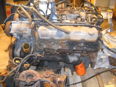 1988 Ford F-250 - Close-up view of a diesel engine, likely out of a truck, with visible wear and tear.