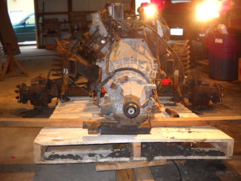 1988 Ford F-250 - Engine and transmission assembly on a wooden pallet, likely for rebuild or transport.