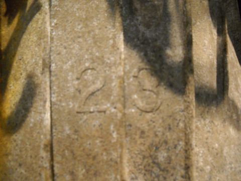 1988 Ford F-250 - Close-up of an engine part with embossed numbers 23, showing texture and shadow.