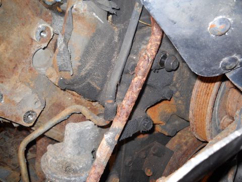 1988 Ford F-250 - This image shows a heavily rusted engine block with various hoses and mechanical components visible.
