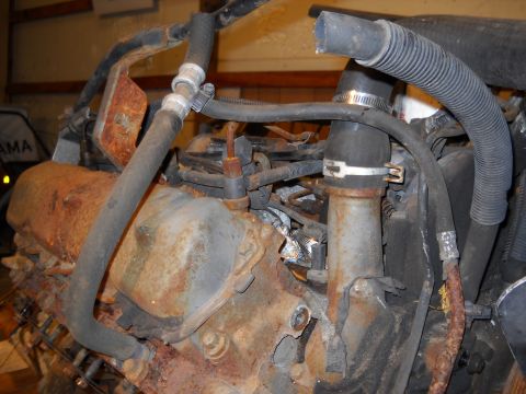 1988 Ford F-250 - Close-up view of a corroded engine, showing hoses and various metal parts.
