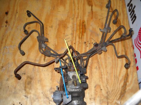 1988 Ford F-250 - Fuel injection pump assembly with various fuel lines, likely for a diesel engine rebuild.