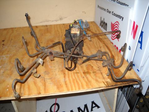 1988 Ford F-250 - Diesel fuel injection pump with associated fuel lines, likely for a truck engine rebuild.