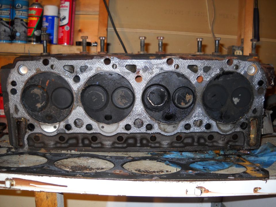 Engine cylinder head with four sets of valves, resting on a table