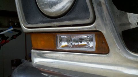 1978 Ford Bronco - This vehicle's front corner features a headlight, amber marker light, and a clear fog light assembly.