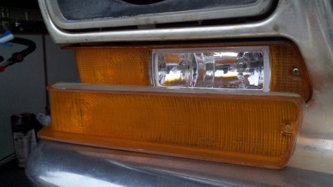 1978 Ford Bronco - Close-up of vehicle's front amber turn signal and clear marker light assembly.