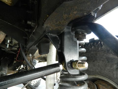 1979 Ford Bronco - Undercarriage view of a vehicle's suspension components and tire.