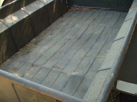 1979 Ford Bronco - Interior view of a truck bed, showing the ribbed floor and textured side panels.