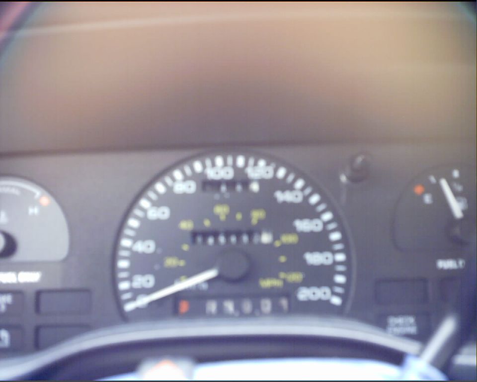 Dashboard with speedometer, fuel gauge, and odometer visible. Odometer reads 19001