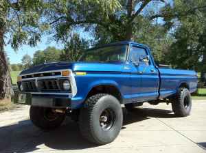 1995 Ford Bronco - A blue pickup truck is shown from the front three-quarter angle.