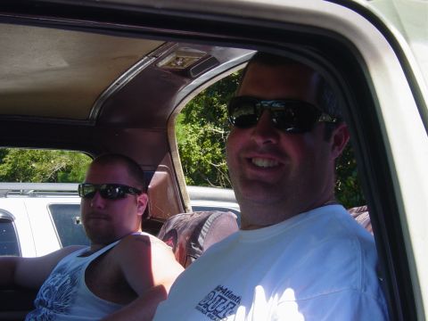 1979 Ford Bronco - Interior view of a vehicle with two men, one smiling at the camera.