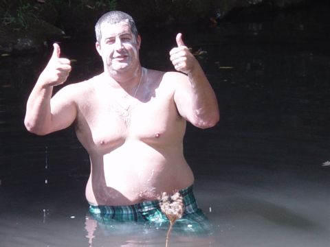 1979 Ford Bronco - A man gives a double thumbs-up while standing in murky water, his face and chest covered in white powder.