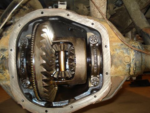 1989 Ford F-250 - Close-up view of an open differential, showing the ring and pinion gears. Text is visible on the bearing cap.