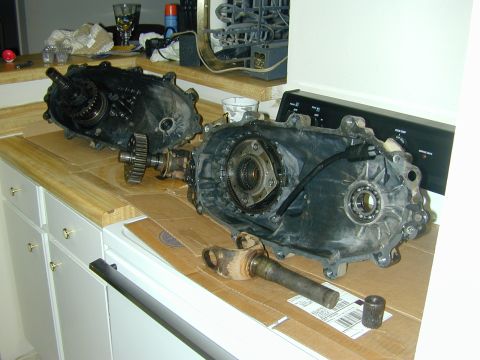 1996 Ford Bronco - Disassembled vehicle drivetrain components are laid out on a countertop, possibly for repair or inspection.