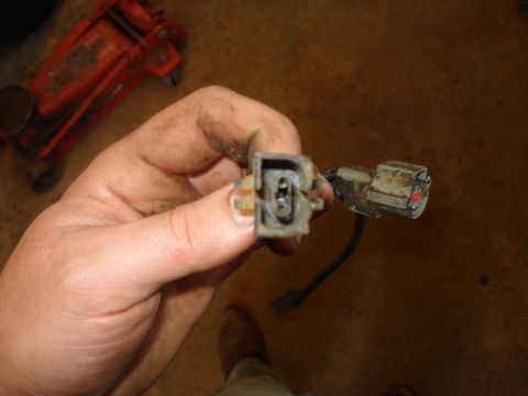 1989 Ford F-250 - A close-up view of a dirty electrical connector, likely for a vehicle's wiring harness.