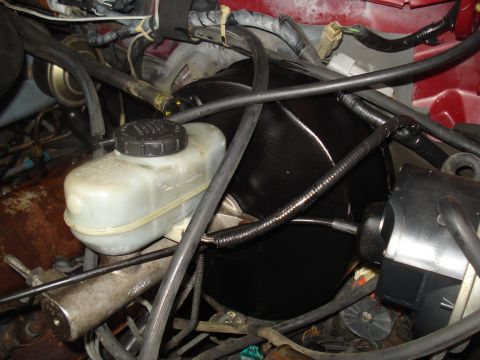 1989 Ford F-250 - The brake master cylinder and booster assembly is visible, with various hoses and electrical connections.