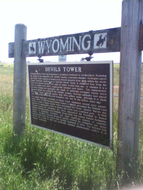 2007 Dodge Caliber - A signpost in a grassy field displays information about Devils Tower in Wyoming.