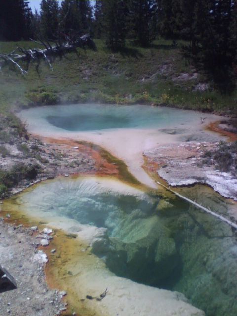 2007 Dodge Caliber - Natural hot springs display vibrant colors from mineral deposits and emit steam into the surrounding landscape.