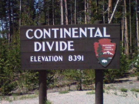 2007 Dodge Caliber - Sign indicates the Continental Divide at an elevation of 8391 feet, set against a backdrop of pine trees.