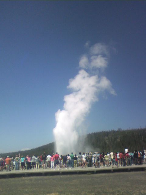 2007 Dodge Caliber - Tourists gather to witness the eruption of Old Faithful geyser in Yellowstone National Park.