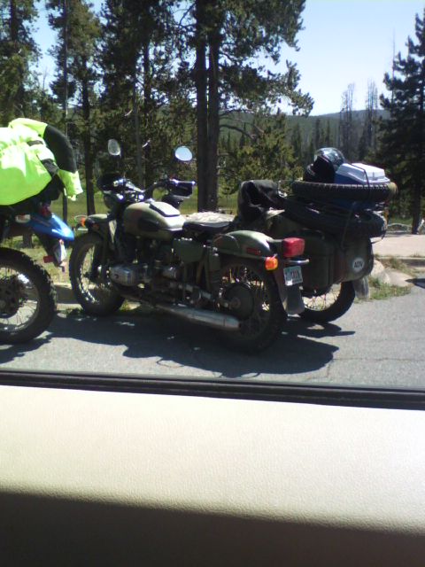 2007 Dodge Caliber - Two motorcycles are parked side-by-side in a wooded area.