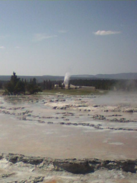 2007 Dodge Caliber - A geyser erupts, sending steam high into the air in a natural landscape.