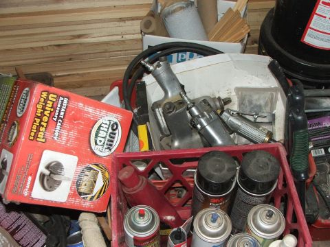 1965 Ford Mustang - A collection of automotive tools and parts are stored in a red crate.