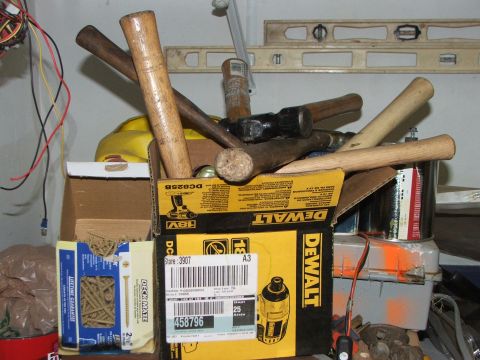 1965 Ford Mustang - A collection of hammers and other tools are stored in a box, with a DeWalt power tool box visible.