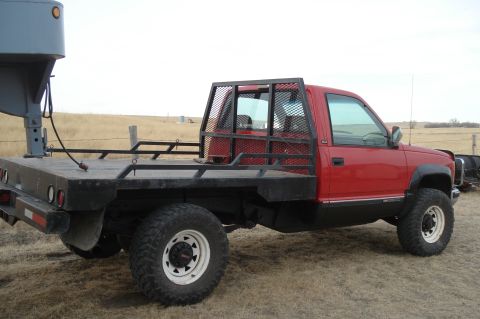 1994 GMC Sierra 3500 - This 1994 GMC Sierra 3500 flatbed truck is equipped with a gooseneck hitch and a custom bed.