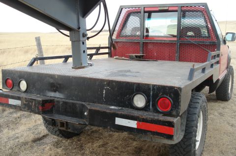 1994 GMC Sierra 3500 - Rear view of a red 1994 GMC Sierra 3500 flatbed truck with a gooseneck hitch.