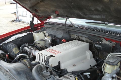 1994 GMC Sierra 3500 - Close-up of a vehicle's engine bay, a 'Turbo Power' engine cover.