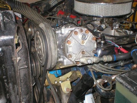 1978 Ford Bronco - Engine bay detail an AC compressor and associated drive belts and pulleys.