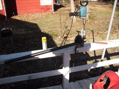 1986 Ford Bronco - A jackhammer is set up on a railing, ready to work on a pipe, with a can of lubricant and tools close at hand.