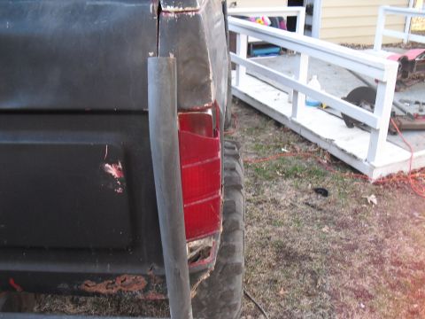 1986 Ford Bronco - Rear view of a 1986 Ford Bronco, highlighting body damage and a missing taillight lens.