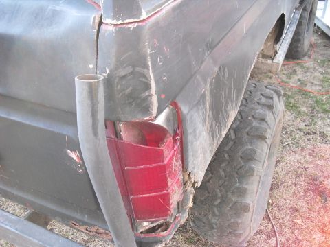 1986 Ford Bronco - This photo shows the rear quarter panel of a Ford Bronco, a broken taillight and visible rust.