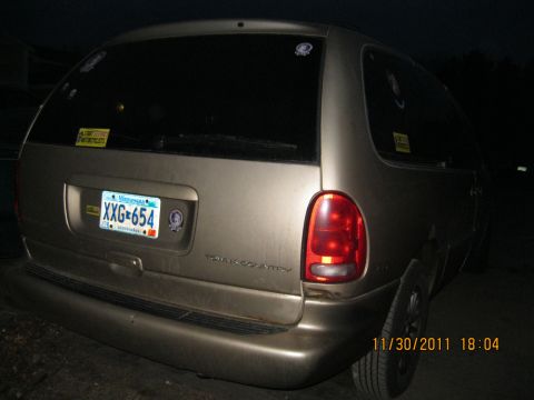 1984 Chevrolet C/K Pickup - Gold Dodge Grand Caravan with Minnesota plate XXG-654. The tailgate reads "TOWN & COUNTRY".