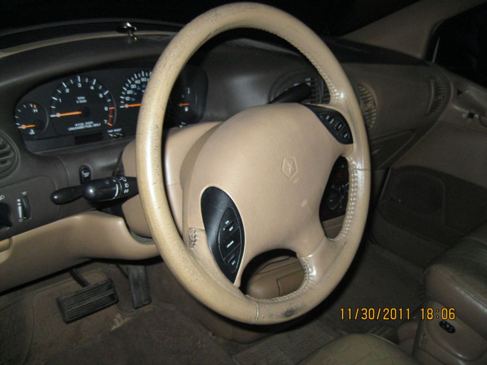 Car interior showing dashboard, steering wheel with controls, and gauges. Date stamp reads 11/30/2011