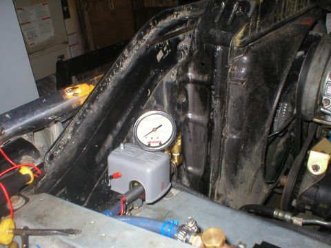 1978 Ford Bronco - Close-up view of engine bay components including a pressure gauge and control box.