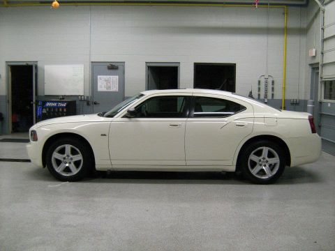 1988 Mercury Grand Marquis - Side view of a white sedan in a garage setting.