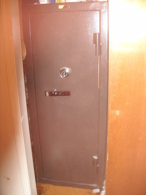 2012 Ford Mustang - A brown metal safe is shown in a room with wooden walls.
